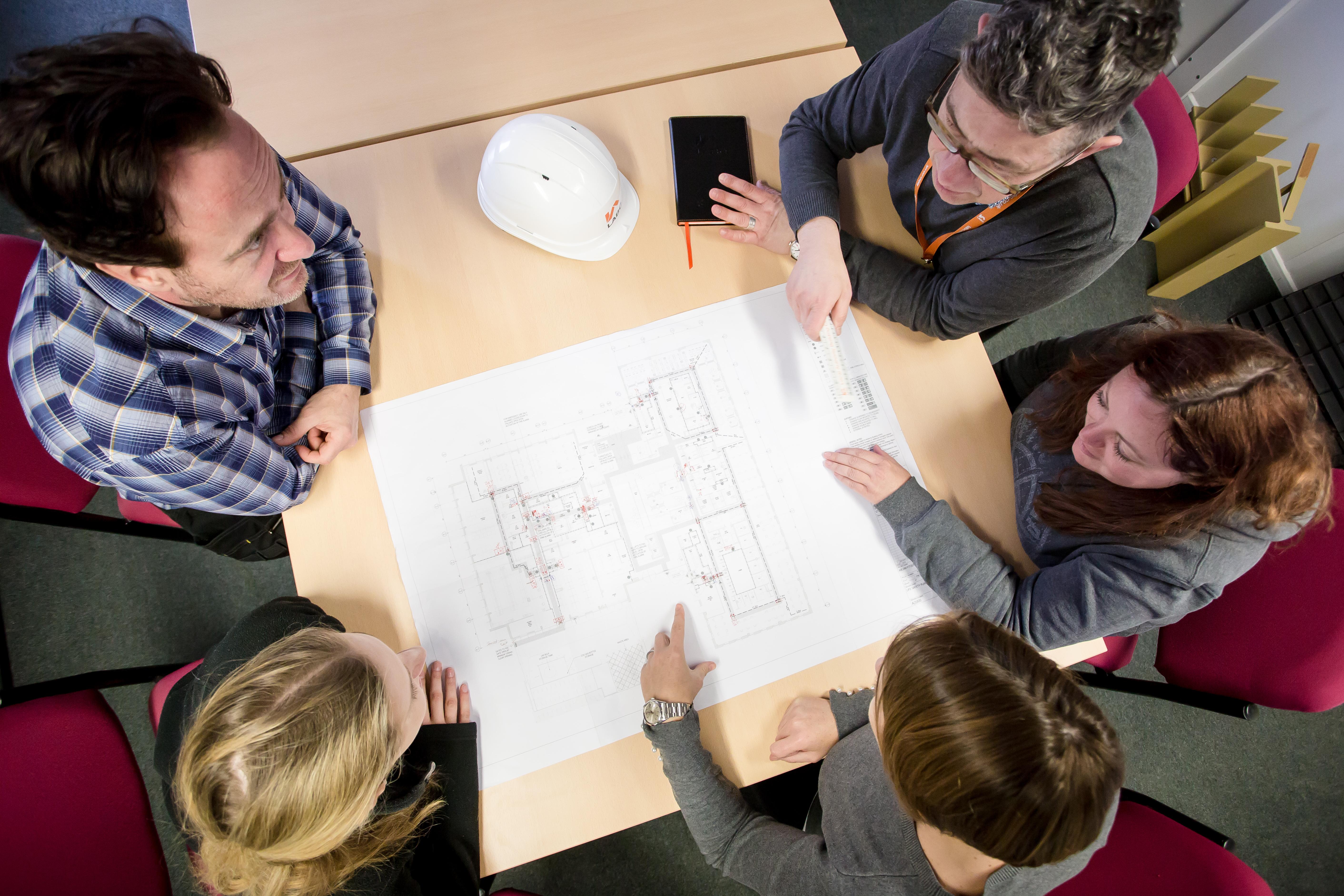 LABC building control team discussing plans with clients in a meeting room